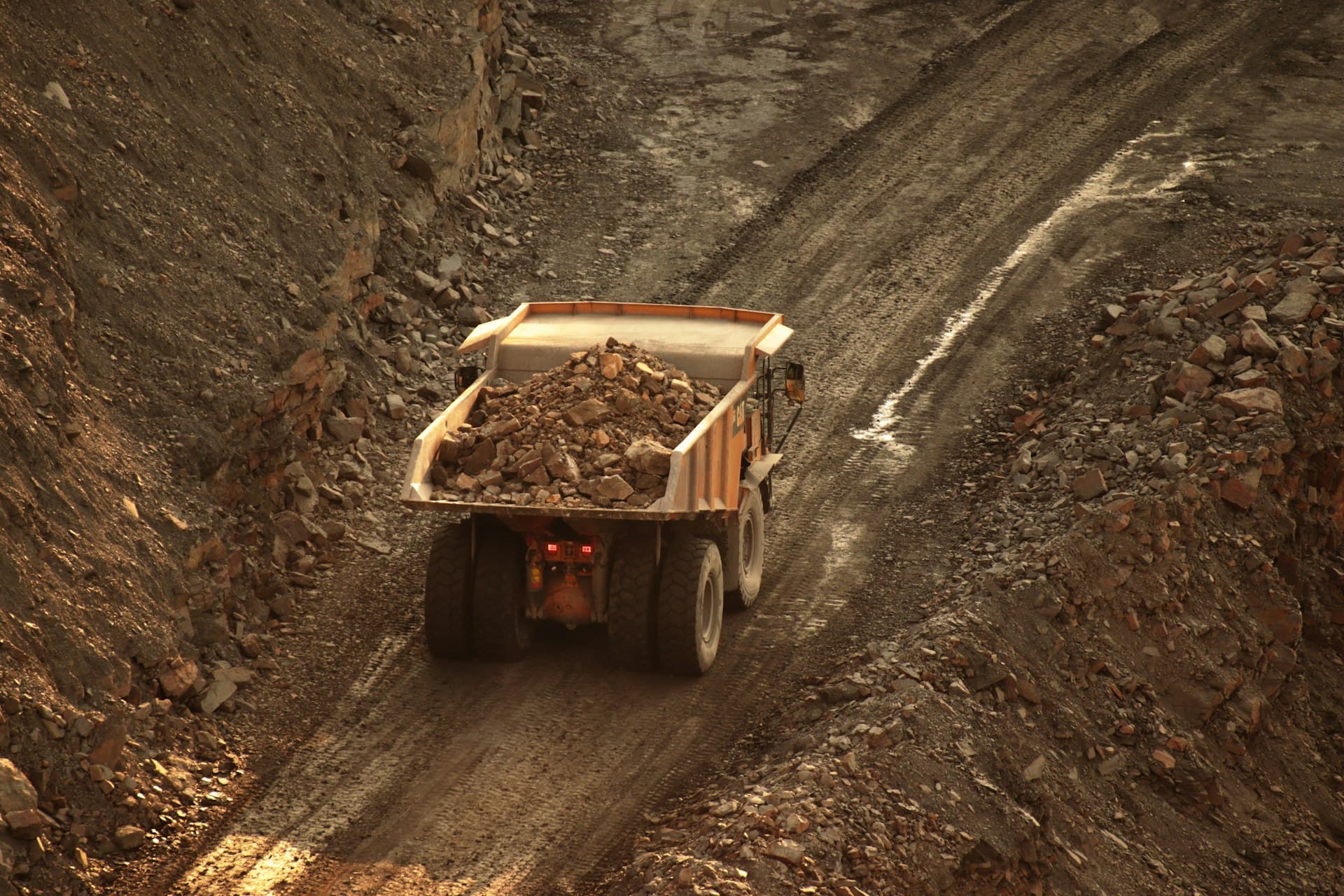 Autonomous haul truck hauling material on a mine site road